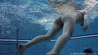 roxalana cheh, the sexy redhead, stuns while swimming underwater in a public spot.