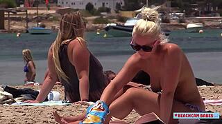 Underaged girls in their bra and panties watching other girls sunbathing without tops on the beach