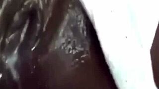 the ebony woman using a huge vibrator for solo squirting fun