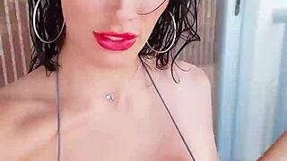 A French woman wearing a silver bikini pleasuring herself.
