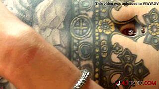 Behind the scenes, Marie Bossette gropes her shaved boobs while getting tattooed
