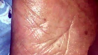 Girlfriend gives footjob in detailed scene.