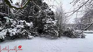 Asian girl gives a blowjob in the snow, almost getting caught in the public park.