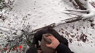 Asian girl gives a blowjob in the snow, almost getting caught in the public park.