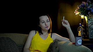 Brunette woman sucks on cigarette while gazing voyeuristically