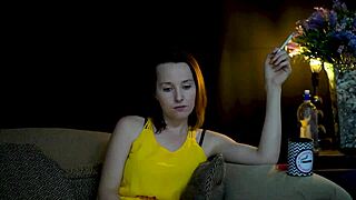 A brunette is seductively smoking while she looks at you