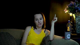 Brunette woman sucks on cigarette while gazing voyeuristically