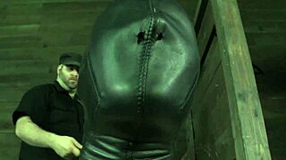 A redhead submissive is tied up and wears a mask while being stimulated