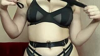 bdsm girl demonstrates spanking with whip for humiliation