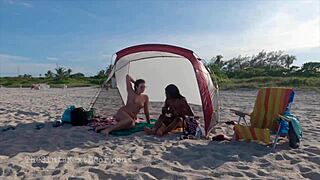 hey, check out this double handjob happening on a public beach!