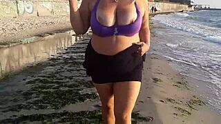 this horny milf is masturbating her wet pussy on the beach, showing off her big tits and fat ass while feeling so aroused outside