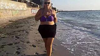 this horny milf is masturbating her wet pussy on the beach, showing off her big tits and fat ass while feeling so aroused outside