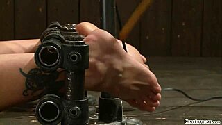 bound blonde gagged and anal plugged in rough device setup. extreme play in bizarre scene.