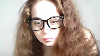 Topless teen pornstar exposes natural tits and pussy on cam in outdoor public setting.