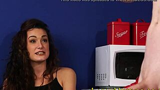 clothed brunette keeps an eye on the action in high-def fetish scene