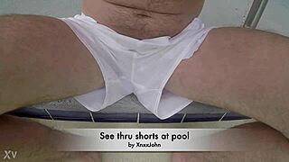 Pool boy in see-through outfit underwater