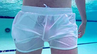 Pool boy in see-through outfit underwater