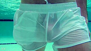 Pool boy in see-through outfit underwater