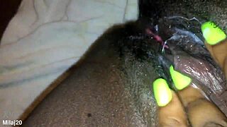 an old ebony woman fingers her tight wet pussy