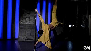 sexy gay guy does an acrobatic striptease while dancing on the pole.