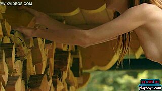 Tiny redhead strips naked for outdoor wood chopping session
