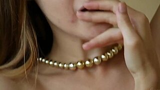 A beautiful blonde teen performs a sexy striptease on the sofa