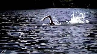 Beautiful blonde swims in the middle of the woods