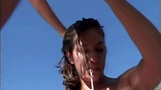 two girls, one black one white, blowing a big cock together