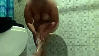 Mature milf exposes big tits and ass in bathroom for assplay humiliation.