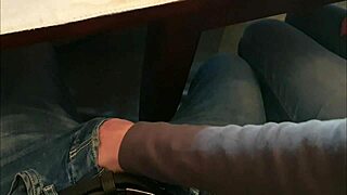 Teacher helps student in classroom during university class