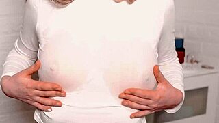 a young beauty teases with juicy breasts and caresses her hairy pussy to climax.