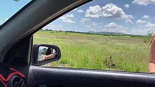A young woman hitchhiking and getting a ride from a couple