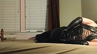 this crossdresser ties himself up in leather boots, gagging and choking on his own ass