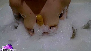 uh, cute teen babe sloppy suckin’ huge dildo in foamy bath... damn hot!