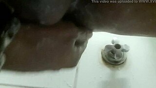 In the shower, he pleasures himself with a dildo