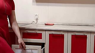 Housewife teases in kitchen with striped panties and smelly socks. She washes dirty feet in sink.