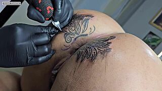 Curly haired beauty modifies her tattoo around a huge cunt for interracial creampie