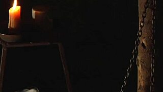 Naughty lesbian slave bound and licking her mistress's pussy on knees.