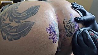 Curly haired beauty modifies her tattoo around a huge cunt for interracial creampie