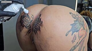 Curly haired beauty modifies her tattoo around a huge cunt for interracial creampie