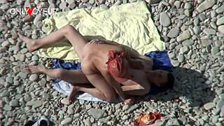 Beach voyeur catches busty milf with young guy