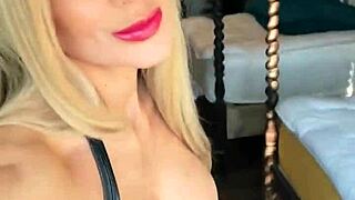 Woman Dominates in Wetlook Suit and Leather Boots Display