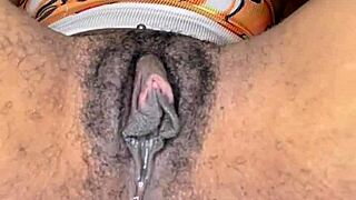 Horny slut edges her ebony hairy pussy with tongue piercing.