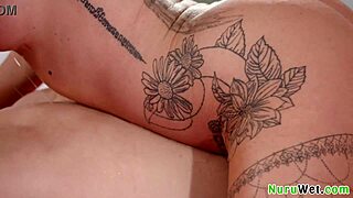 Stunning busty brunette prepares her client for a relaxing nuru massage with oils.