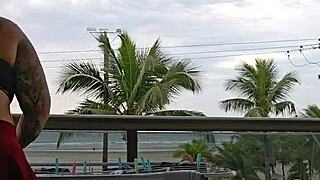 Girl flashing ass on balcony in skirt