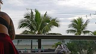 Girl flashing ass on balcony in skirt