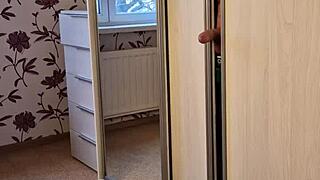 Tanned young girl with natural tits in jeans gives blowjob in wardrobe