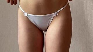 this innocent redhead girl slowly strips down, teasing in her tight skirt.