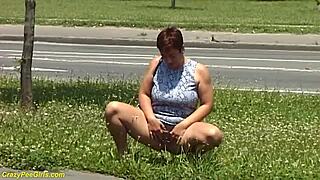 Damn, check this redhead BBW milf peeing out in public view!