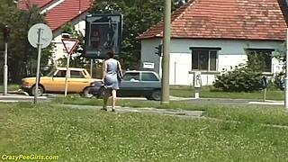 Damn, check this redhead BBW milf peeing out in public view!